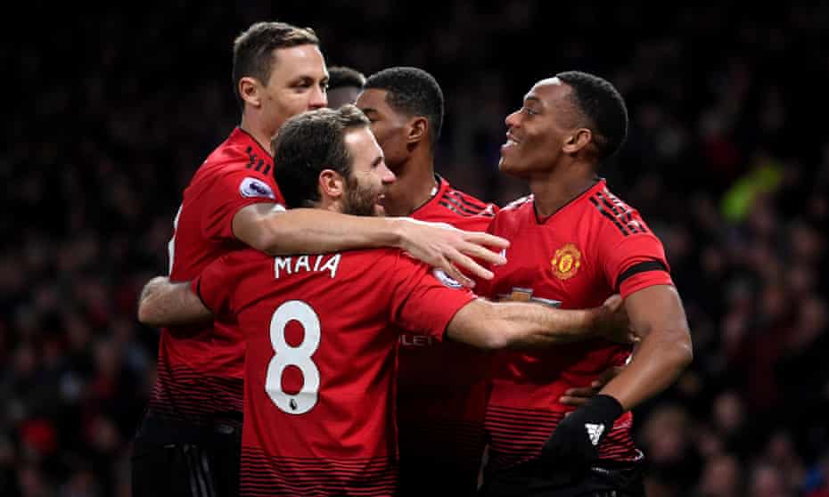 Anthony Martial (right) celebrates with teammates after scoring his team’s second goal.