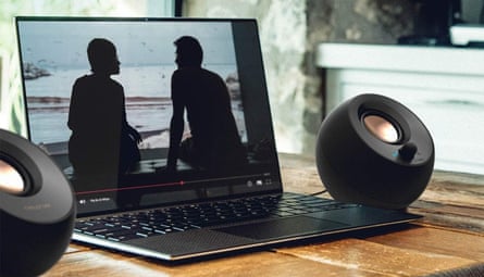 A pair of Creative Pebble V3 next to a laptop
