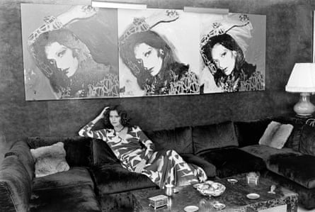 A model poses in Diane von Fürstenberg’s living room, wearing a wrap dress that was part of the designer’s 1975 spring collection. The painting of Von Fürstenberg on the wall is by Andy Warhol.