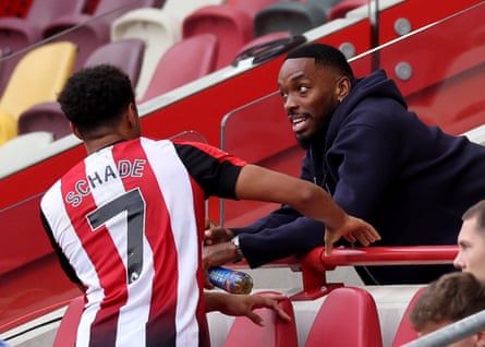 Al-Ahli's Ivan Toney speaks with Kevin Schade after the match.