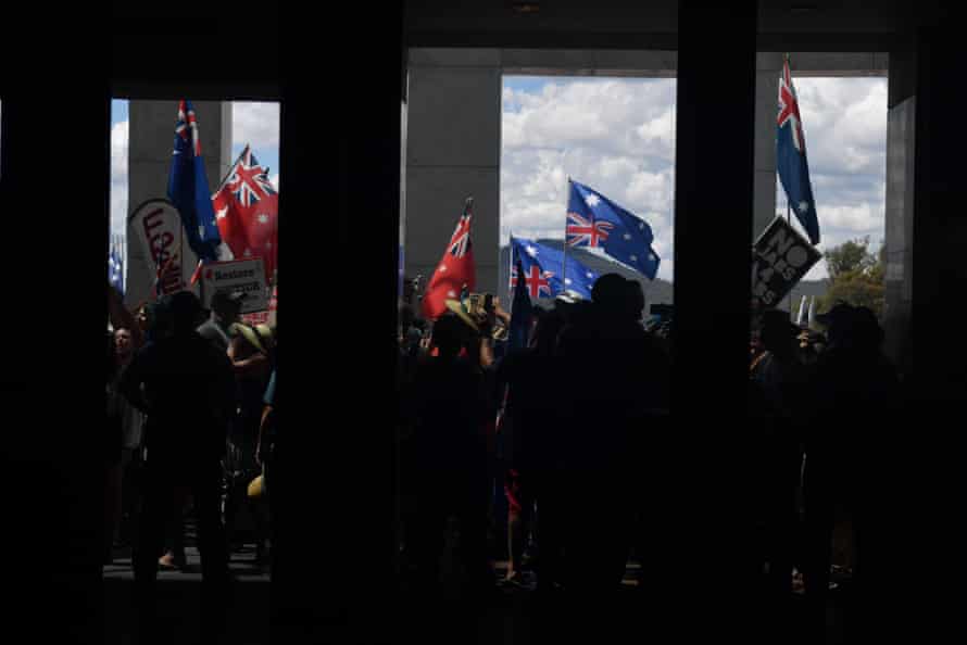 Demonstrators protest outside Parliament House in Canberra.