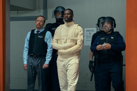 Omar Sy as Assane Diop in Lupin, wearing a straitjacket