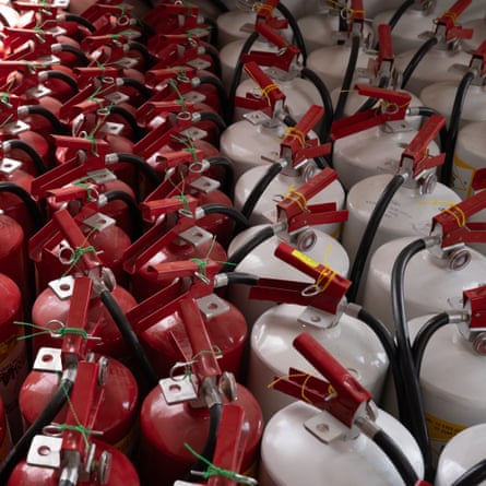 Dozens of fire extinguishers are laid out, ready to be distributed around the track at the Mexico City Grand Prix.