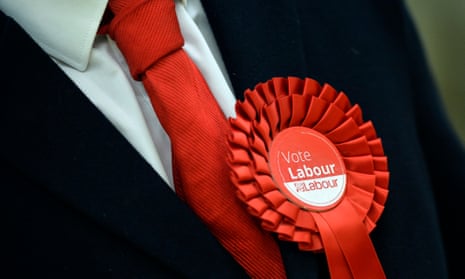 A Labour supporter wears a rosette in support of the party