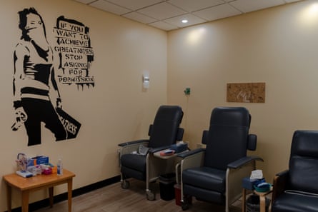 A room with chairs in a row, a mural of a woman on the wall saying ‘If you want to achieve greatness stop asking for permission’