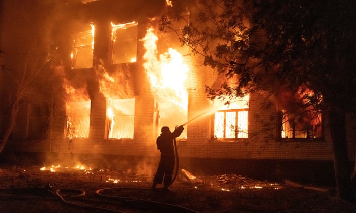 A firefighter extinguishes a burning hospital building hit by a Russian missile strike in Mykolaiv.
