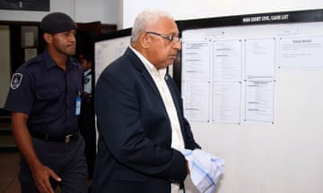 Former Fiji prime minister Frank Bainimarama wearing handcuffs at court