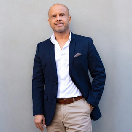 Portrait of Alexis Mohamed standing against a grey backdrop.