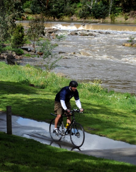 A cyclist rides along the Yarra River near Dights Falls in Collingwood.