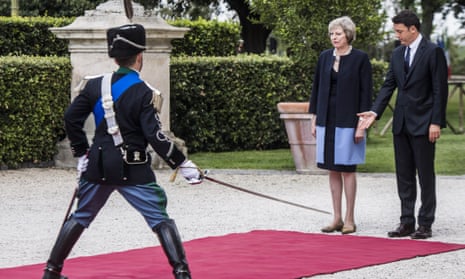Theresa May receives a ceremonial welcome at she arrives in Italy to meet the prime minister Matteo Renzi (right)