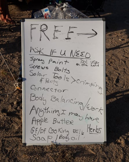 A sign that lists goods and services for free: ‘ask if you need spray paint, solar tools, body balance/work, anything I may have’