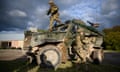 Soldiers from the Royal Anglian Regiment leap from their Foxhound protected patrol vehicle on Salisbury Plain