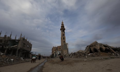 Palestinians go about their daily lives past destroyed buildings at the Nuseirat refugee camp in the central Gaza Strip on March 3, 2025, during the holy Muslim fasting month of Ramadan.