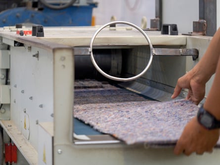 Recycled fluff being moulded into board by Upparel.