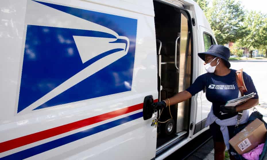 A mail carrier of the United States Post Office (USPS) delivers mail.