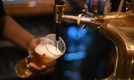An employee pours a pint of Peroni beer on at the bar in the Mad Hatter pub and hotel, operated by Fuller's, in London in November.