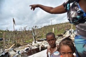 Jaqueline and  children on site of house destroyed by Hurricane Matthew in Roche-a-Bateaux, Haiti