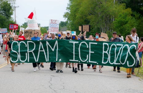 People protest with a banner reading ‘Scram ICE bozos” outside an ICE facility in Scarborough, Maine, a day after ICE agents fatally shot a driver in the nearby town of Biddeford.
