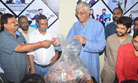 Chhattisgarh health minister, TS Singh Deo, right, brought half a kilo of plastic to the launch of the Garbage Cafe to emphasise that the scheme was for everyone.