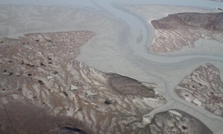 Raised seabeds with some vegetation and active tidal delta mud deposits in Ilulialik, Nuuk fjord, west Greenland.