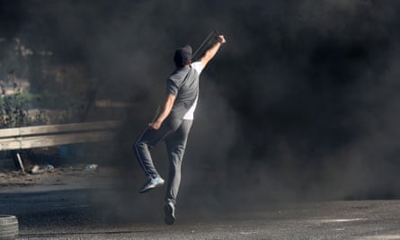 Palestinian protesters burn tyres and throw stones at Israeli forces in the West Bank town of Nablus.