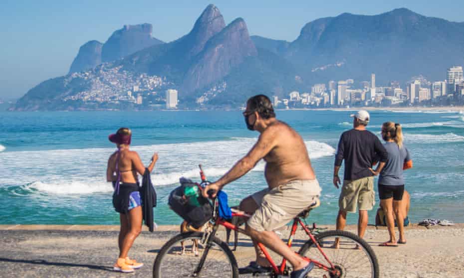 Residents of Rio de Janeiro break social isolation and walk along the beach on 31 May.