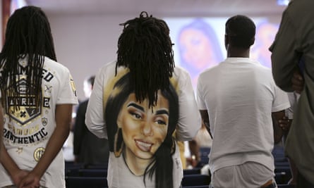 People stand during the funeral for Nia Wilson.