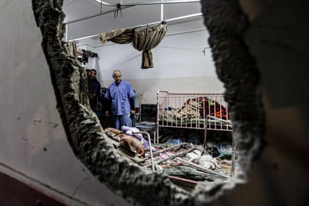 Staff inspect the damage in a room following Israeli bombardment at Nasser hospital in Khan Yunis in the southern Gaza Strip on 17 December 2023.