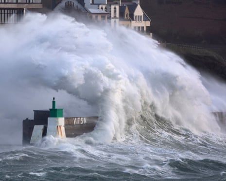 A huge wave crashes on the jetty of the harbor of Le Conquet, western France