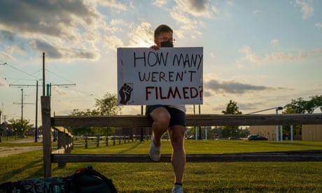 US-POLITICS-POLICE-RACISM-UNREST<br>A protester holds a sign before a march against the shooting of Jacob Blake in Kenosha, Wisconsin on August 27, 2020 - A strong police presence brought relative calm to the Midwestern US city of Kenosha early on August 27 after three nights of violence over the police shooting of a black man, as NBA stars led the sporting world in a wave of protest against racism. (Photo by Kerem Yucel / AFP) (Photo by KEREM YUCEL/AFP via Getty Images)
