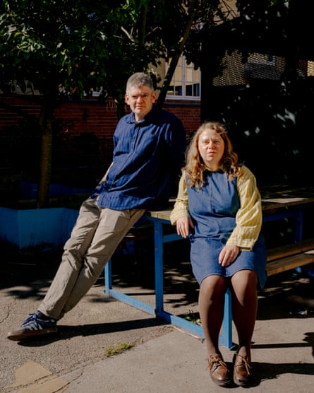 Oliver and Anne-Louise perched on an outdoor table and benches