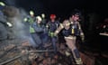 Rescuers remove a body bag after a drone attack on the eastern Ukrainian city of Kharkiv killed at least three and injured dozens on 4 April