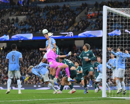 Vitor Reis heads the ball away for Manchester City.