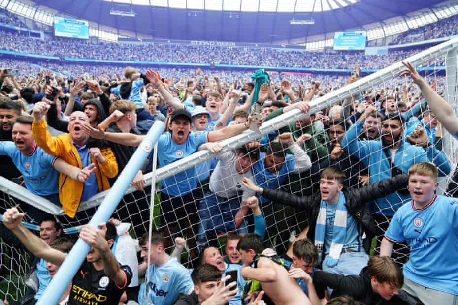 Manchester City fans invade the pitch after their side won the Premier League following the dramatic 3-2 victory over Aston Villa.