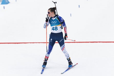 Julia Simon gestures towards the TV compound as she crosses the finish line to win the women’s 15km individual biathlon.