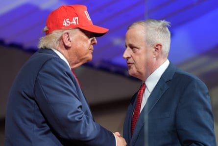 Man in cap shakes hands with other man