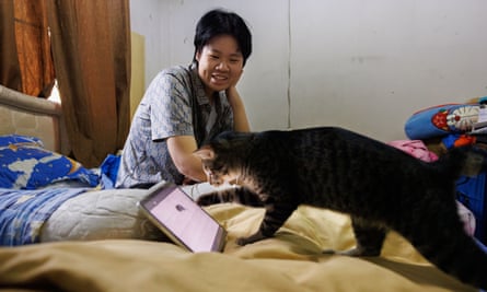 Thaipreecha plays a cat YouTube channel for her pet in the bedroom of her parents’ house in Bangkok, Thailand.