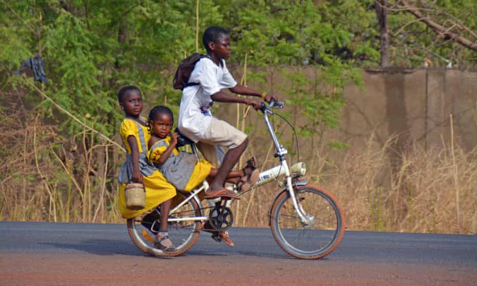 Two girls in Ghana get a bike ride to school