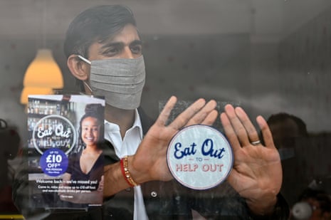 Rishi Sunak places an “eat out to help out” sticker in the window of a business during a visit to Rothesay on the Isle of Bute, Scotland, in August 2020.