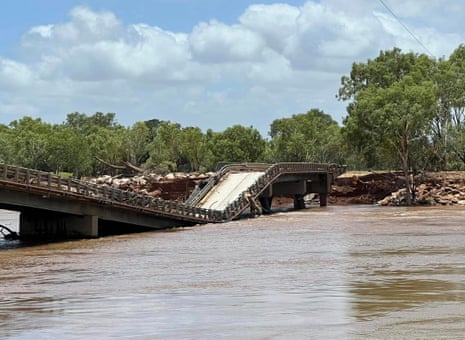 The Brooking channel bridge is damaged and collapsed as flood waters flow past