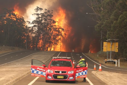 Flames cross the Princes Highway at Sussex Inlet, New South Wales.