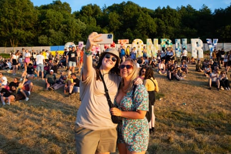 Festivalgoers Beth Cook and Becca Fowler take a selfie with the iconic sign.