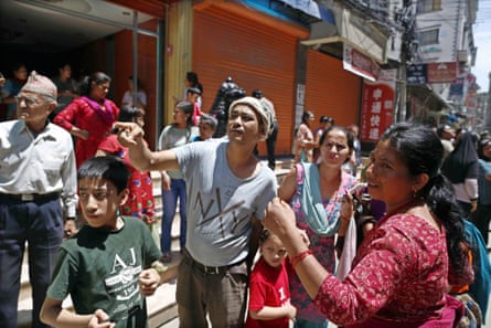 People stand in the street in Kathmandu after the 7.3-magnitude earthquake