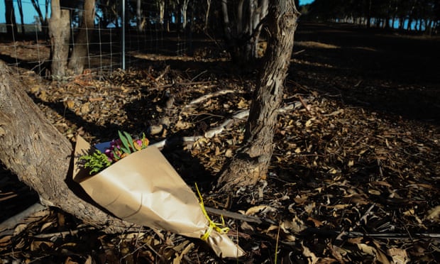Flowers are left next to a police roadblock where police are investigating the death of seven people in suspected murder-suicide in Osmington, east of Margaret River, 11 May 2018.