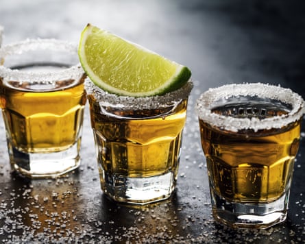 Tasty alcohol drink cocktail tequila with lime and salt on vibrant dark background. Closeup. Horizontal.