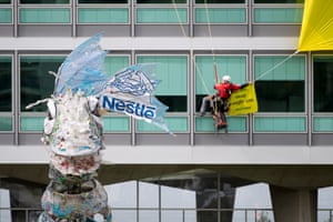 Greenpeace activists stage a demonstration outside the Nestle headquarters in Vevey, Switzerland