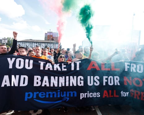 Manchester United fans protest against their owners outside the stadium before the match against Manchester City