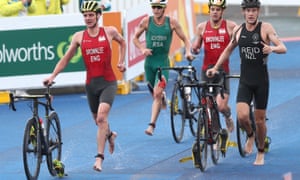 Alistair Brownlee (left) and his brother Jonny leave the water and grab their bikes for the second stage of the triathlon. They finished 10th and seventh respectively.
