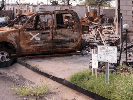 burned-out truck with white x spray-painted on it