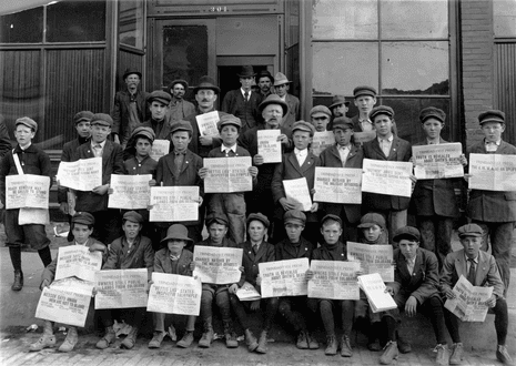 UMWA coalminers and their sons pose holding newspapers reading ‘Trinidad Free Press’ with headlines about the strike against CF&I in Ludlow.